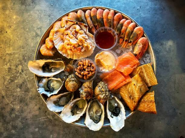 istock Platter of fresh seafood on textured metallic background 1437459793