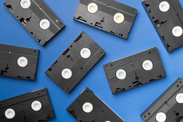 istock Pattern made with old tape VHS cassette on color background, top view 1437459968