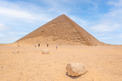 Red Pyramid, Dashur, Necropolis, Egypt - July 19, 2022:  The Red Pyramid, also called the North Pyramid, is the largest of the pyramids located at the Dahshur necropolis in Cairo, Egypt. It was the third pyramid built by Old Kingdom Pharaoh Sneferu, and was built 2575–2551 BCE. Named for the rusty reddish hue of its red limestone stones, it is also the third largest Egyptian pyramid, after those of Khufu and Khafre at Giza. It is also believed to be Egypt's first successful attempt at constructing a \