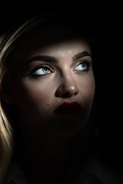 istock Beautiful woman portrait partly face covered with shadow 1437468722