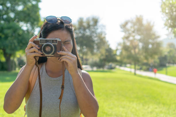 istock asian woman taking a photo with a camera with copy space 1437471356