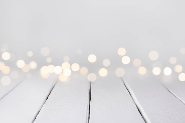 istock White wooden table with bokeh blurry lights with place for product display or copy space 1437476263