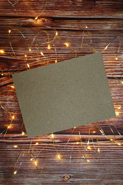 istock Empty paper craft with LED light on wooden background 1437476331