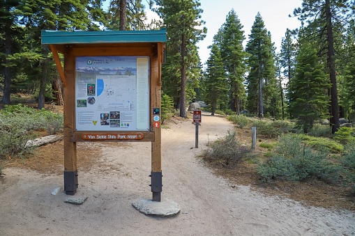 Stateline, Nevada, United States – June 16, 2020: A sign marks the trailhead for visitors hiking to the Tahoe Rim Trail or the waterfall inside Van Sickle Bi-State Park.