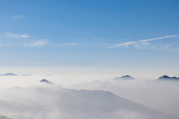 istock Overlooking view of a mountain range covered with a white fog 1437481313