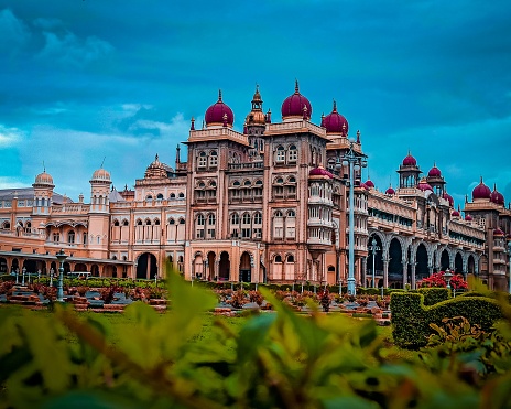 The exterior design of the beautiful Mysore Palace against cloudy sky