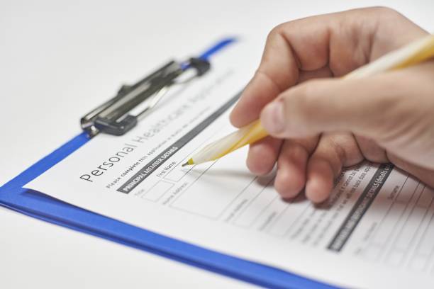 istock Person filling the insurance application 1437481465