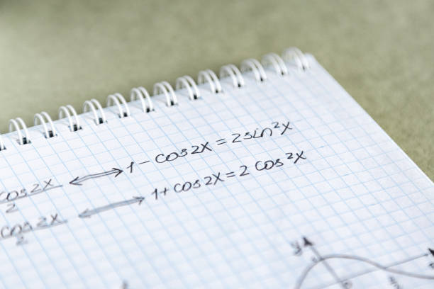 istock Closeup shot of trigonometric formulas written on a notebook paper 1437481521