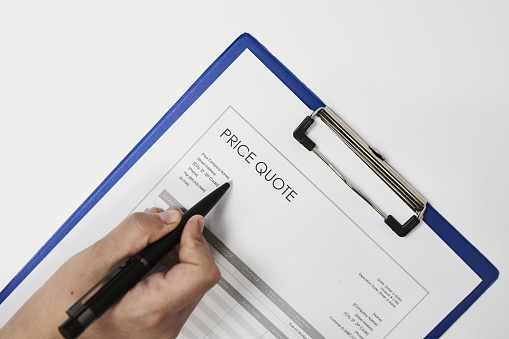 A closeup shot of a person filling in a financial document