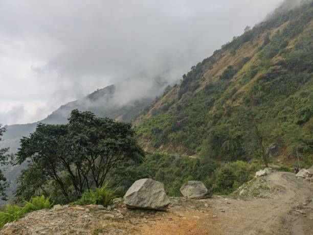 istock Narrow mountain path with a cloudy hill in the background in Nepal 1437482815