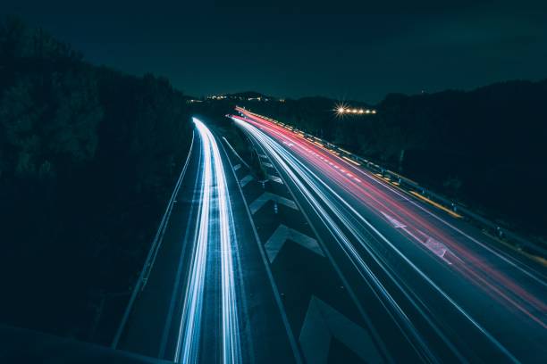 istock Motion of speed light on a night road 1437483625