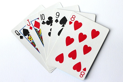 A closeup shot of playing cards on a white background