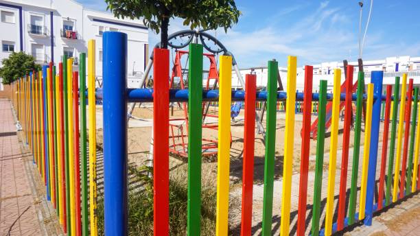 istock Bright multi-colored fence on a children's playground on a sunny day 1437484282
