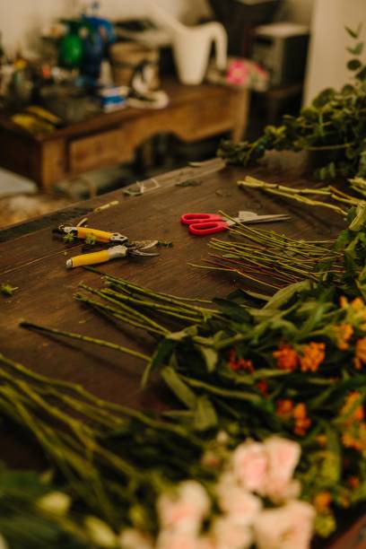 istock Floral design studio with scissors and flowers on the table 1437484411