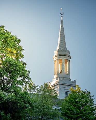 A vertical shot of the spire of the First Parish Church in Waltham, Massachusetts