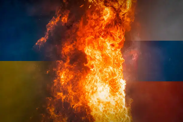 Photo of Ukraine and Russia flags on burning dark background. incitin ethnic hatred. Concept of crisis of war and political conflicts between nations.