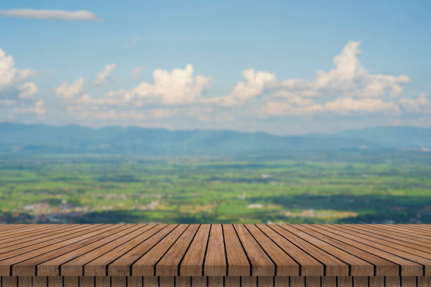 istock wooden table and beauty blur sky and mountains as background. 1437489596