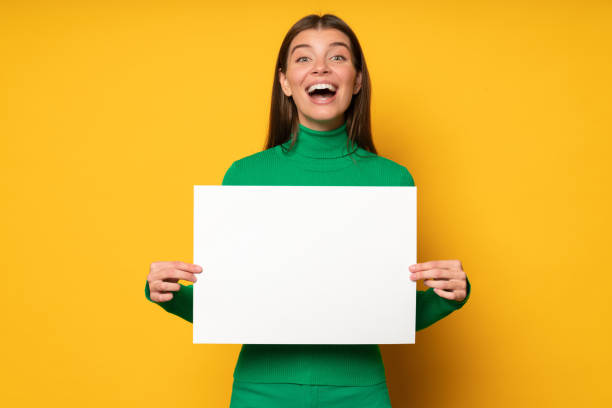 istock Excited surprised student girl holding paper sheet with special offer for education program abroad 1437494500