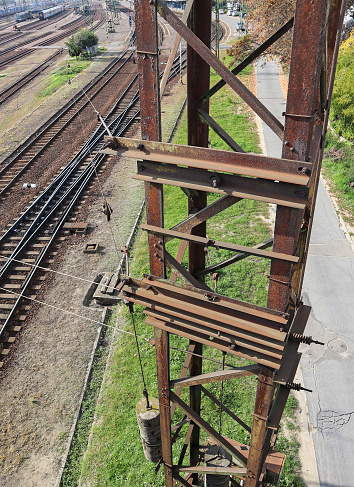 High metal pole next to the railway lines