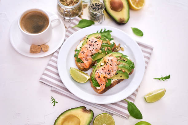 istock Freshly made Avocado, salmon and cream cheese toasts on a white ceramic plate 1437501266