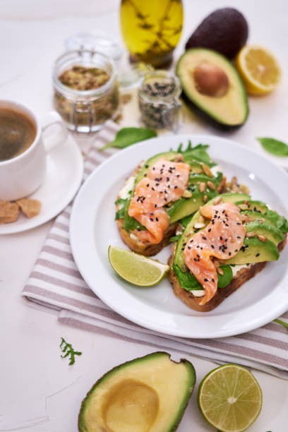 istock Freshly made Avocado, salmon and cream cheese toasts on a white ceramic plate 1437501267
