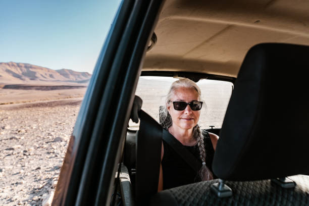 istock Mature woman inside SUV visiting desert in Israel 1437501293