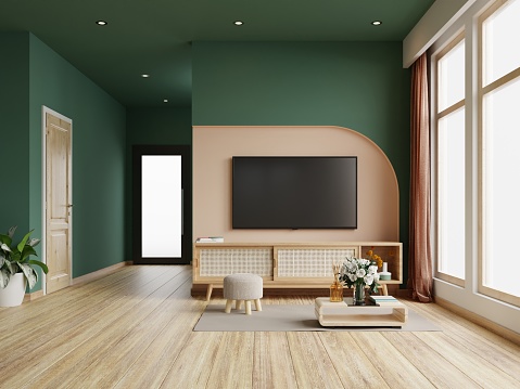Living room with tv on cabinet in dark green color wall,minimalist muji style.3d rendering