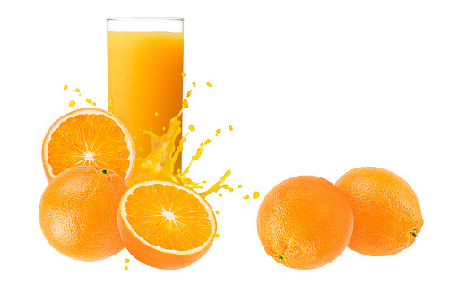 Front view of  a single drinking glass full of orange juice beside a sliced orange isolated on white background