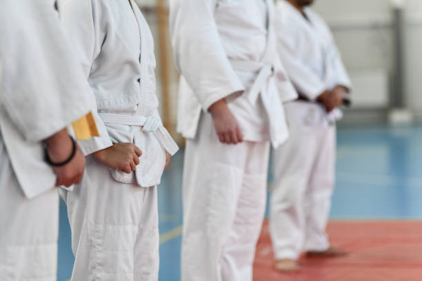istock Judo Players Fixing Their Judogis And Standing Peacefully In Dojo 1437503076