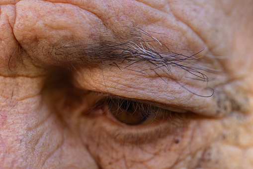 Close up view of a brown eye of a senior man