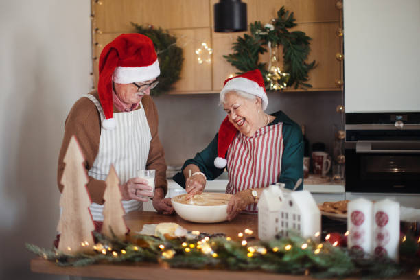 istock Happy seniors baking together Christmas cakes. 1437505671