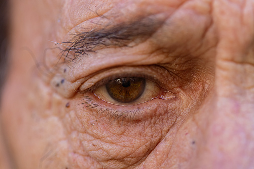 Close up view of a brown eye of a senior man