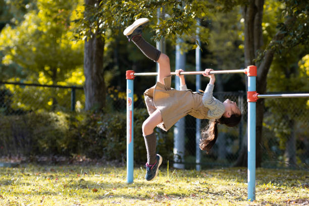 istock Child playing horizontal bar in autumn park 1437506650