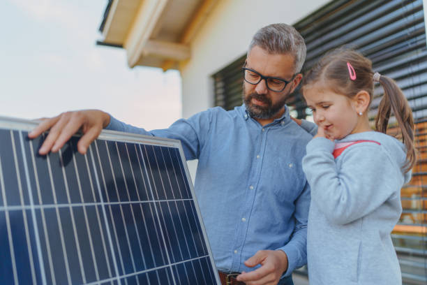 istock Father showing his little daughter solar photovoltaics panels, explaining how it works. Alternative energy, saving resources and sustainable lifestyle concept. 1437508169