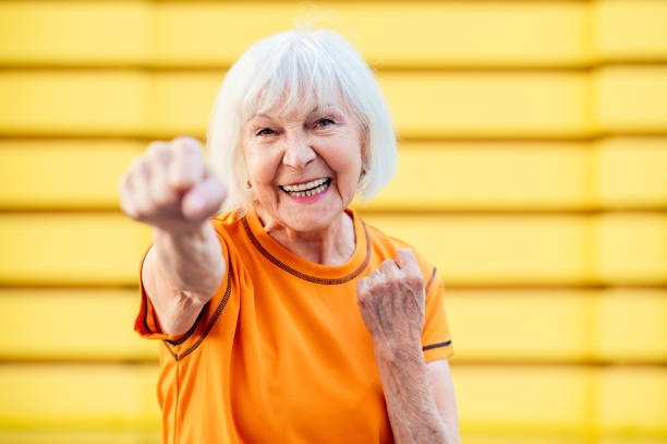 Active senior woman doing fitness in a park stock photo