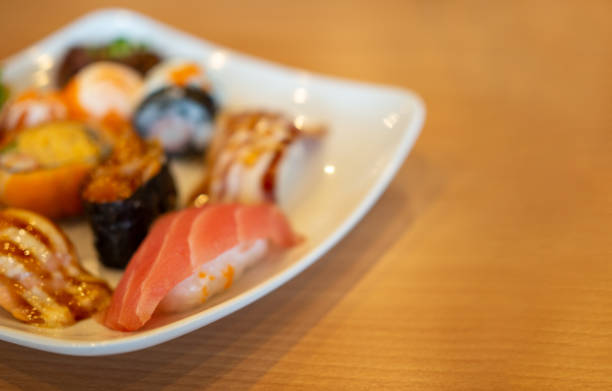 istock Various sushi in a white plate placed on a wooden table 1437509478