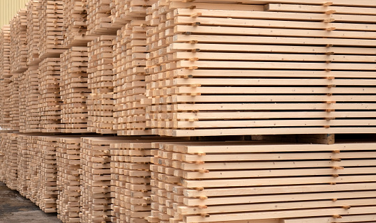 Lumber warehouse. Wooden boards in a stack.