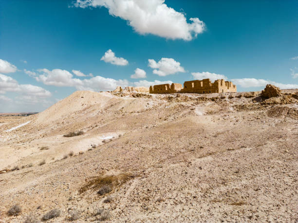 Ancient settlement ruins in Desert Landscape in Middle East. Surreal view of remote location during the day.
