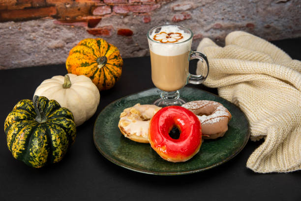 istock Halloween Pumpkins and Colorful Donuts 1437513692