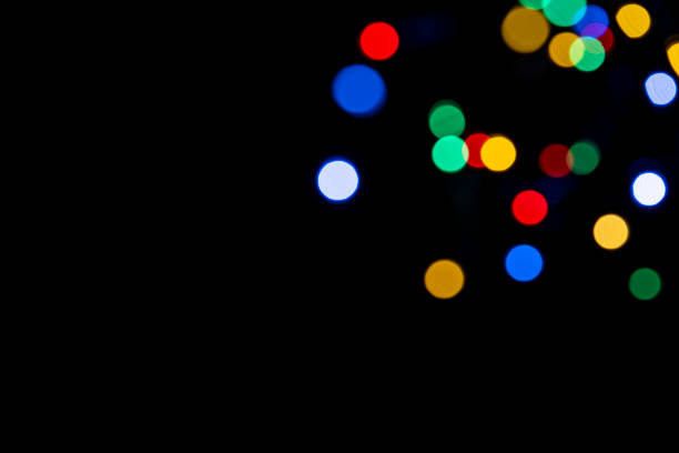 istock Clorful blurred lighs bokeh on black background as a festive backdrop 1437513760
