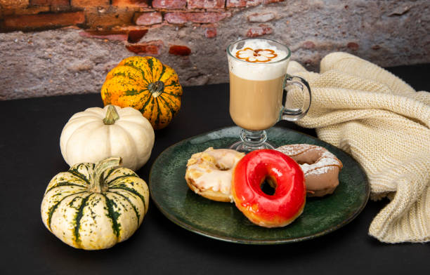 istock Halloween Pumpkins and Colorful Donuts 1437513773