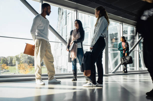 istock Small group of people discussing in the hallway 1437514294