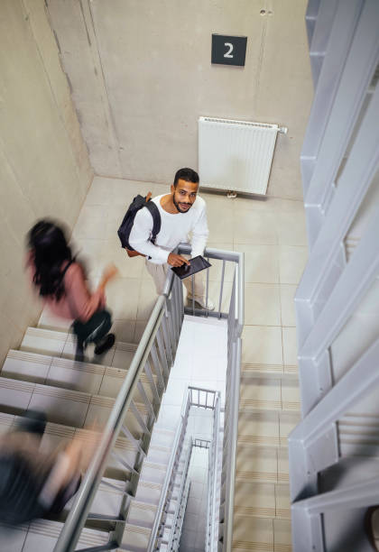 istock Student standing on the staircase of a school building 1437514331