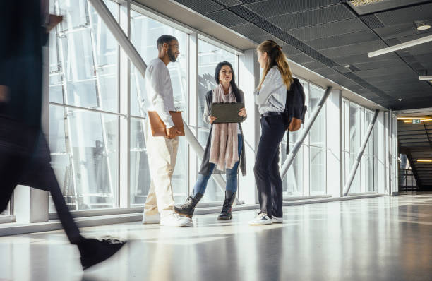 istock Small group of people discussing in the hallway 1437514358