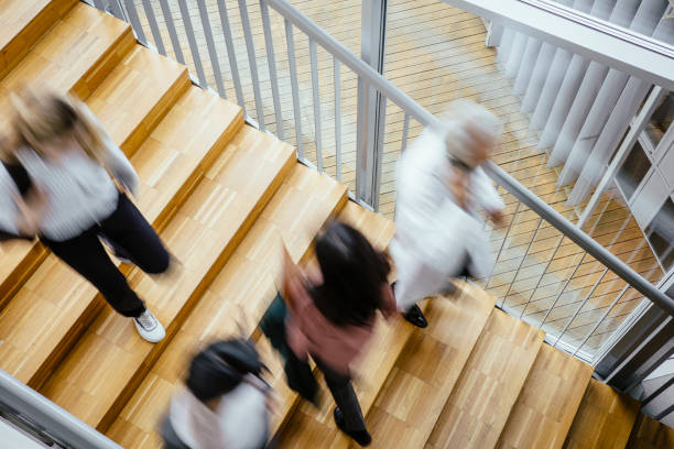 istock Small group of people walking on the staircase 1437514458