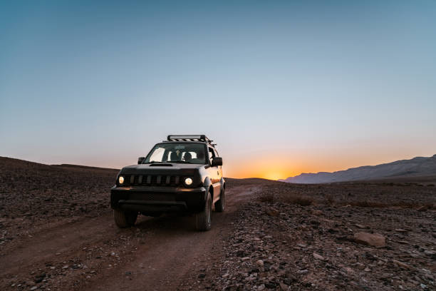Small SUV in Desert Landscape in Middle East stock photo