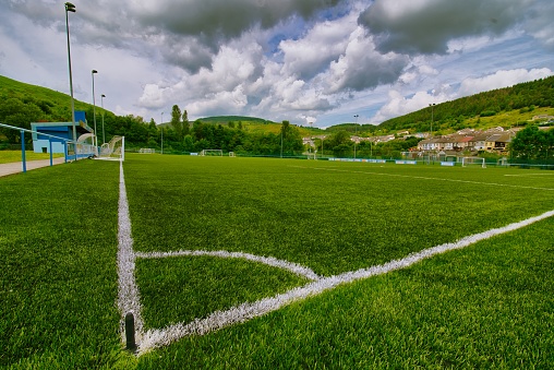 A football pitch in Tonypandy surrounded by valley hills