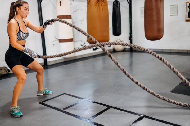 istock Athlete working out with battle ropes at gym 1437519108