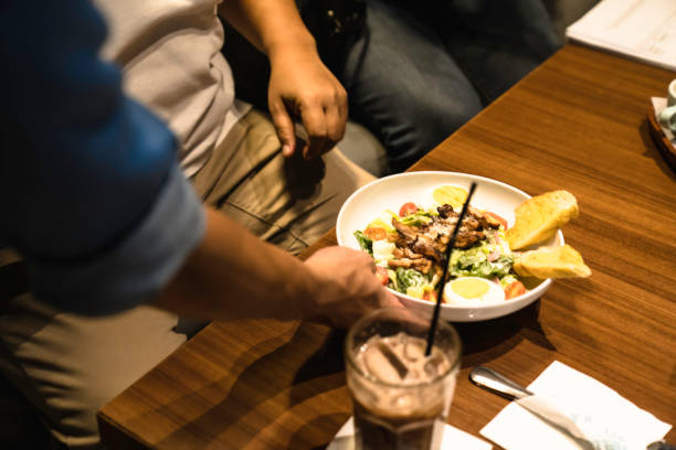 istock close up waitress serving food in the restaurant 1437525570