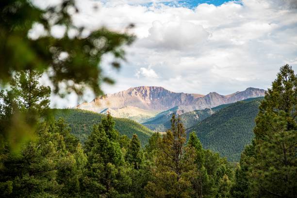 istock Mountain landscape. Beautiful view of the mountain range covered with greenery under cloudy sky 1437525876